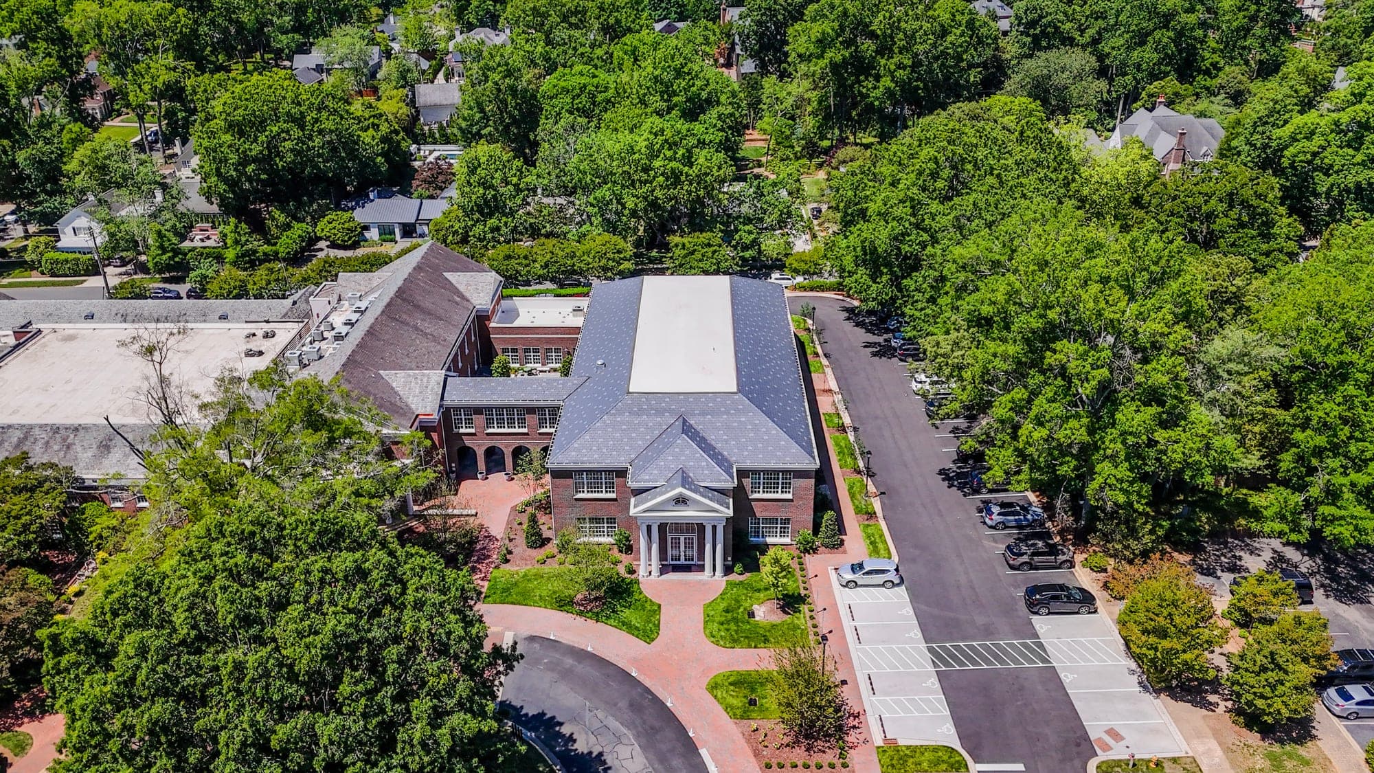 Aerial drone photo of a brick commercial building facade and circular drive in the Charlotte area