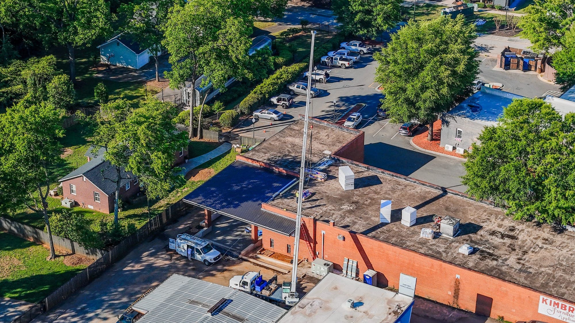 Aerial view of a commercial property exterior with landscaping and parking