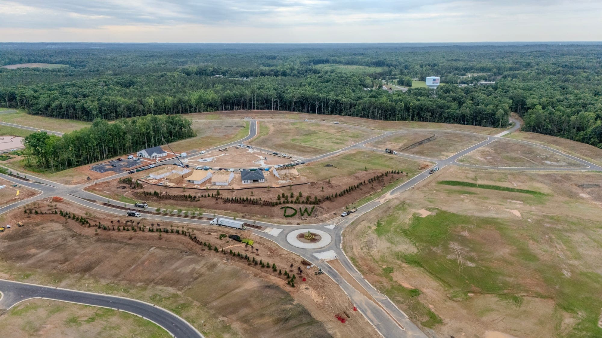 Aerial drone view of a graded land development site with new roads and a roundabout in the Greater Charlotte area