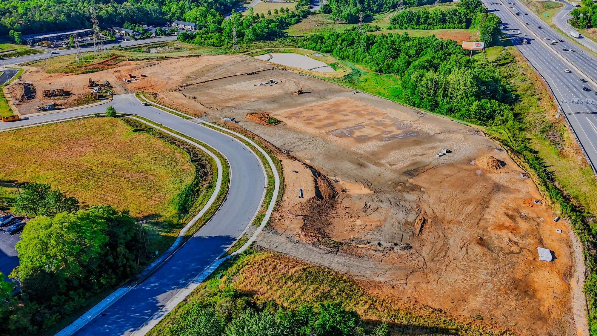 Aerial view of new roads and a roundabout going in at a development site