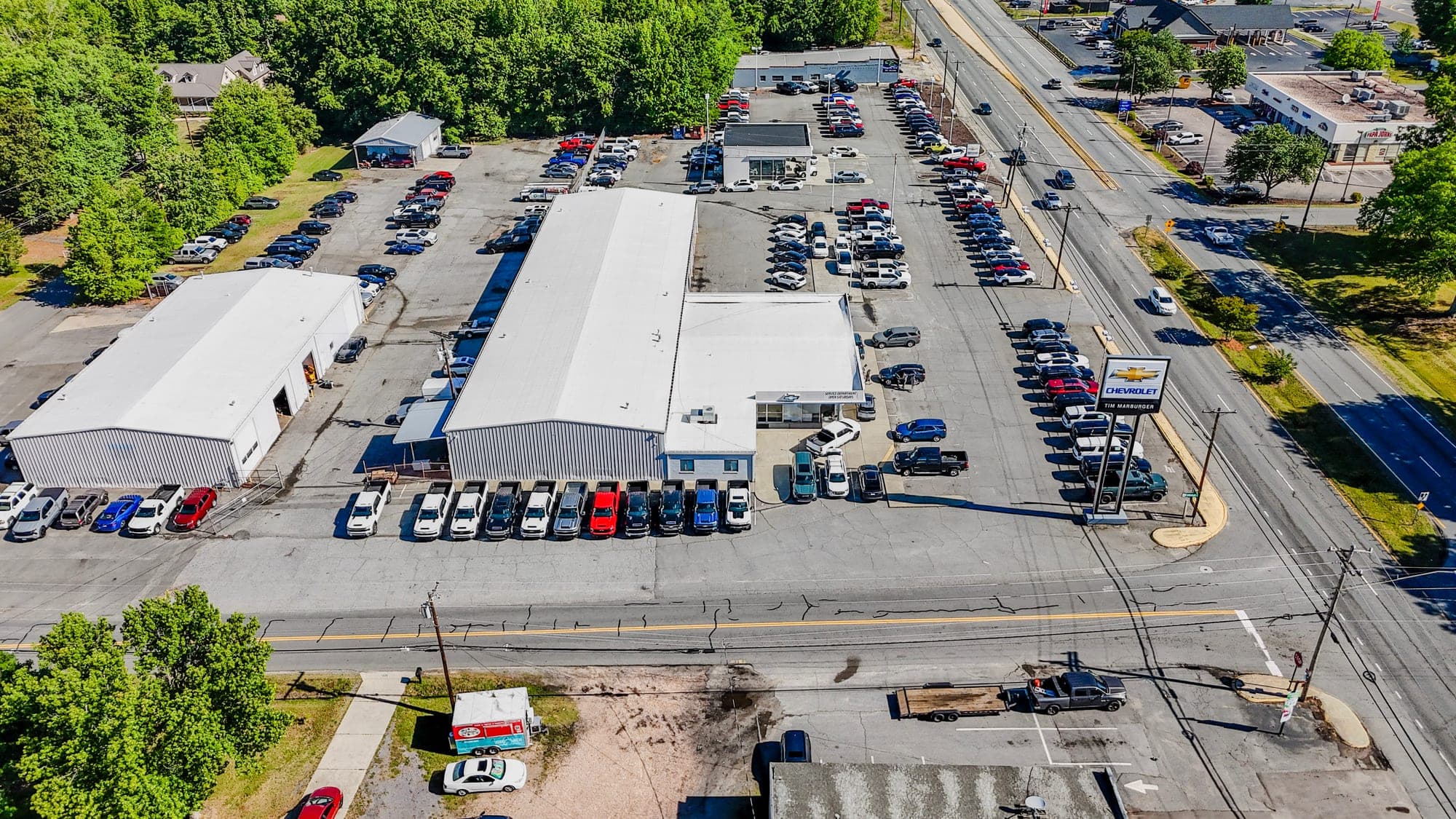 Aerial drone photo of a finished commercial building and clean parking lot ready for occupancy