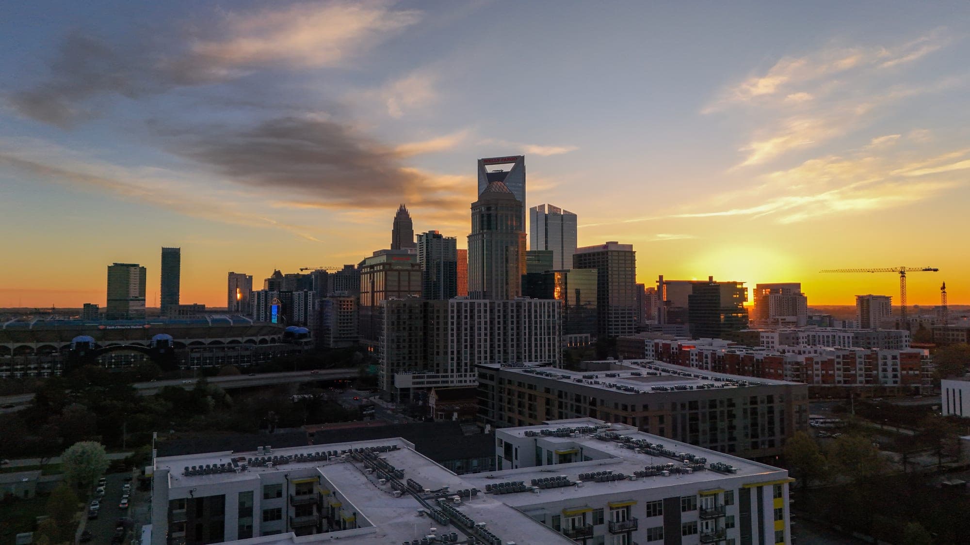Golden hour aerial of the Charlotte skyline at sunset