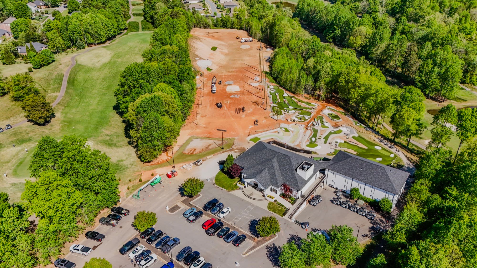 Construction progress aerial of active red-clay earthwork and machinery by SQO SkyWorks, Charlotte NC
