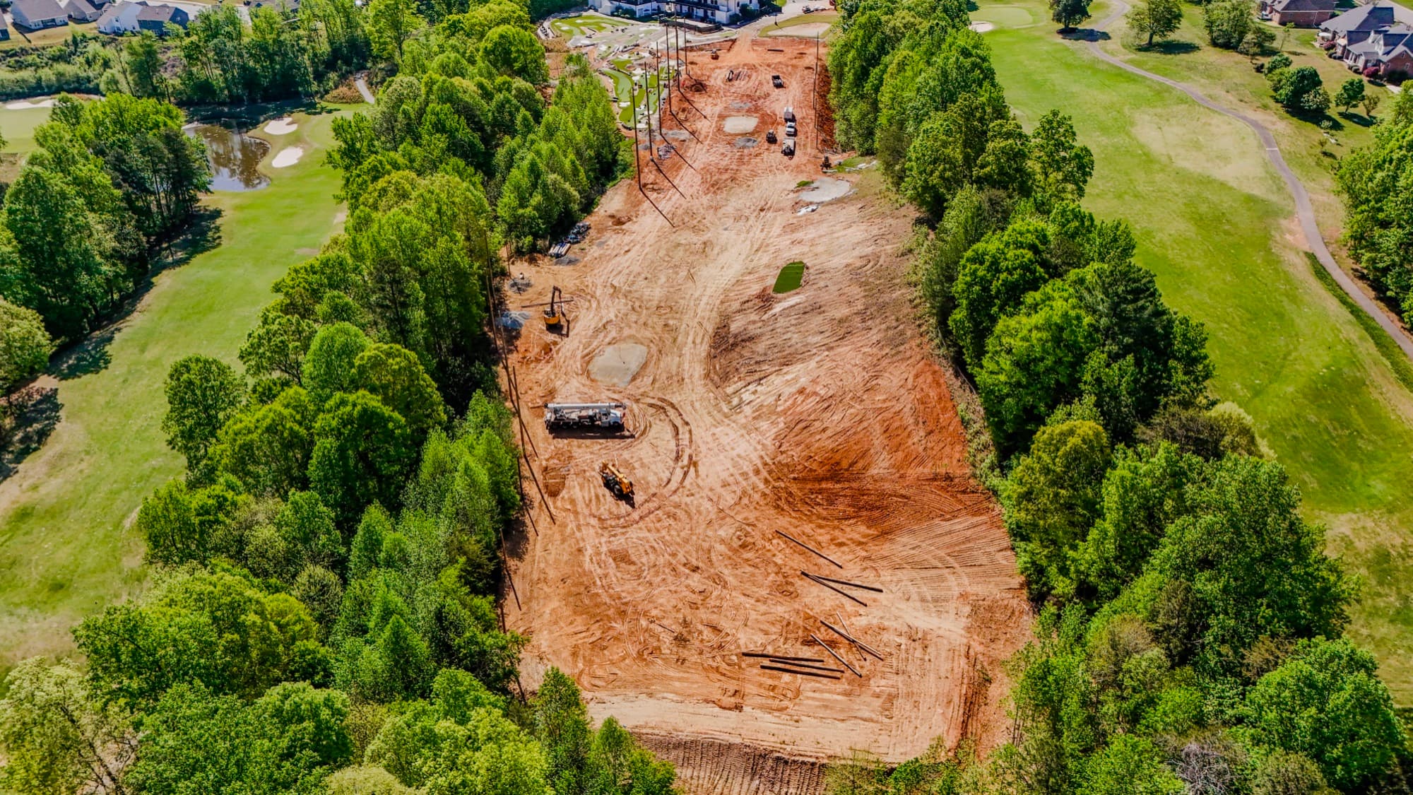 Aerial of a graded construction pad with earthmoving equipment by SQO SkyWorks, Charlotte NC