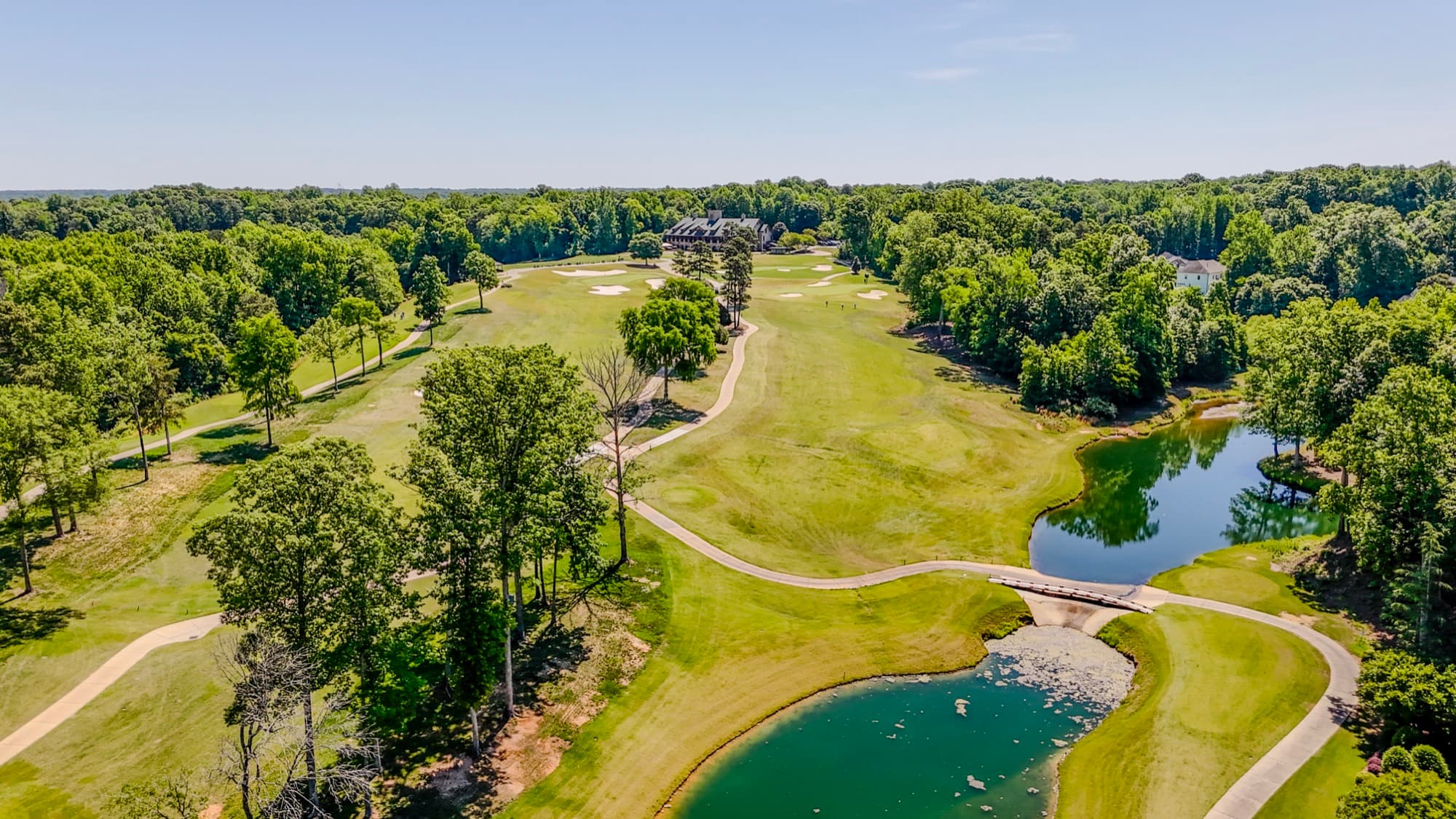 Aerial of a golf course event venue with clubhouse and ponds by SQO SkyWorks, Charlotte NC