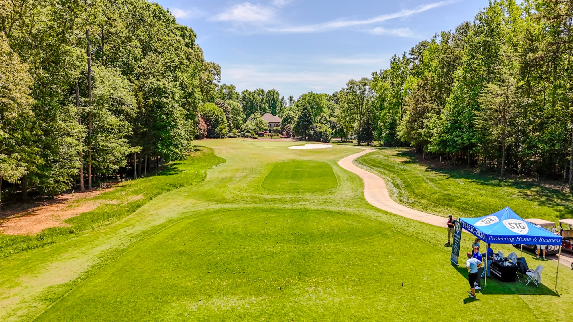 Event coverage aerial of a golf tournament with branded event tents and crowd by SQO SkyWorks, Charlotte NC