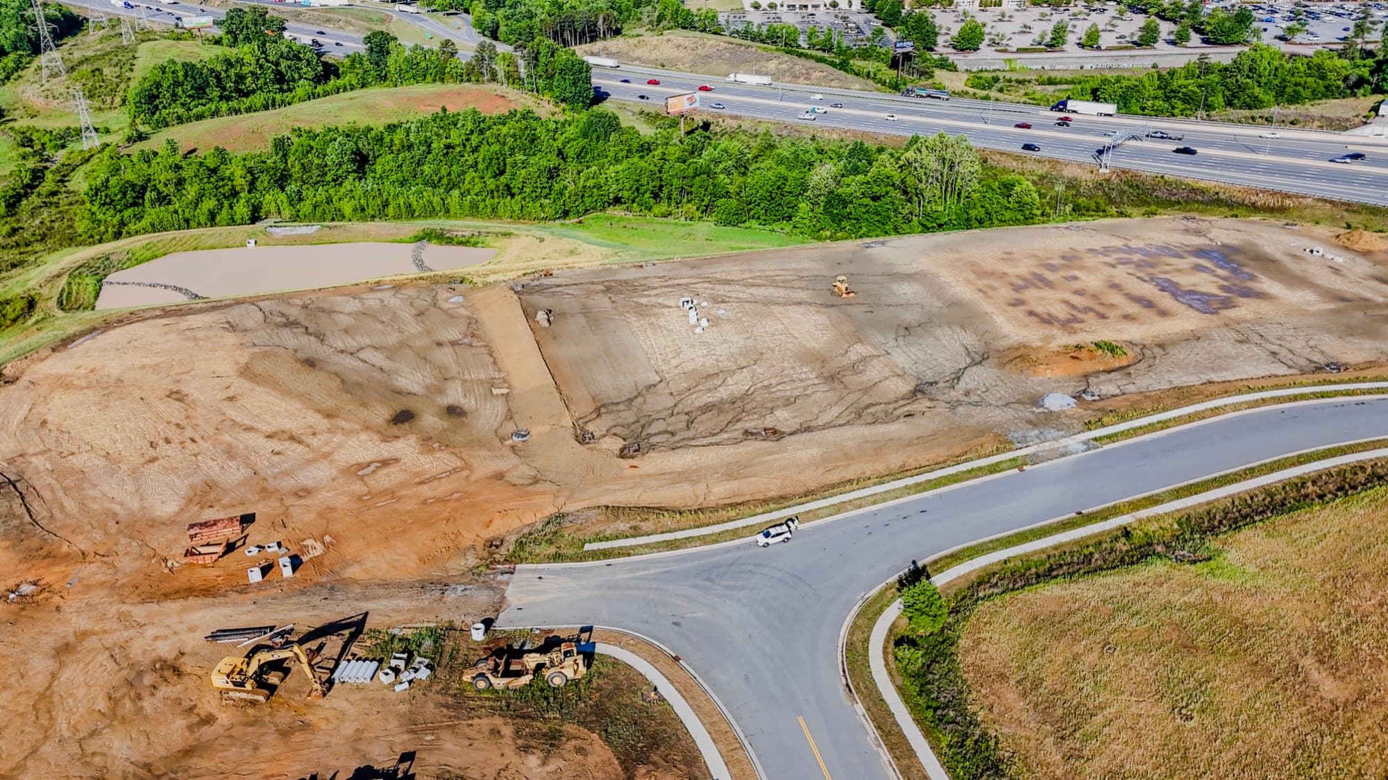 Site documentation aerial of a graded development site and new access road by SQO SkyWorks, Charlotte NC