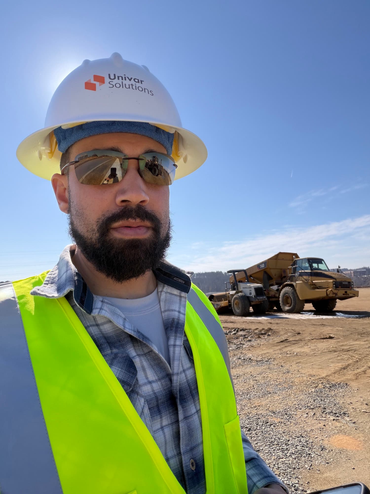 SQO SkyWorks pilot in hard hat and hi-vis at a construction site